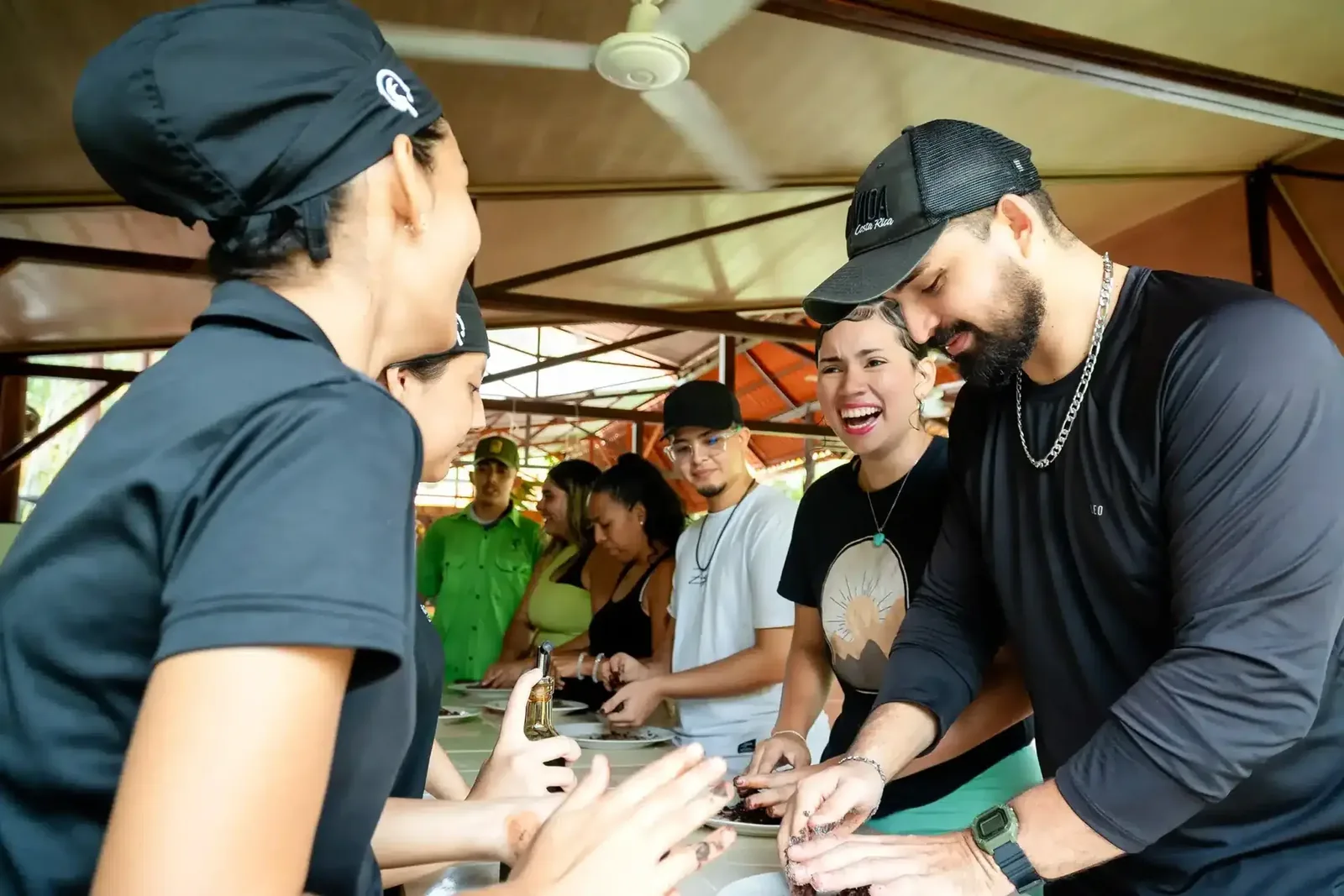 Guests grinding roasted cacao by hand with the guides