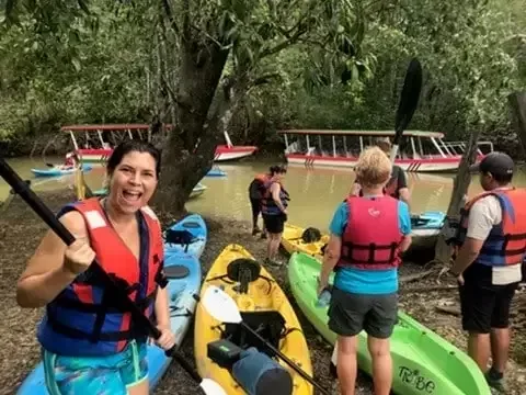 Kayak group following a narrow mangrove channel on the Damas estuary