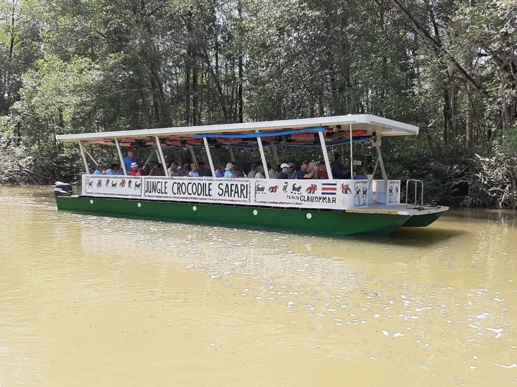 Covered Jungle Crocodile Safari boat carrying guests along the Tarcoles River
