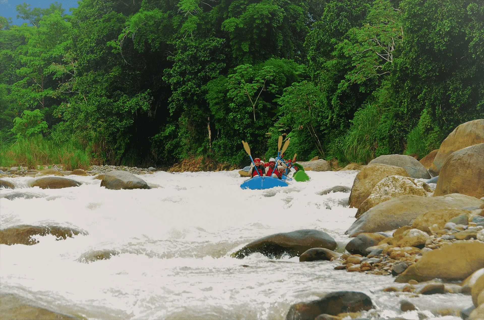 Rafters navigating a steep drop on the Naranjo River in Costa Rica